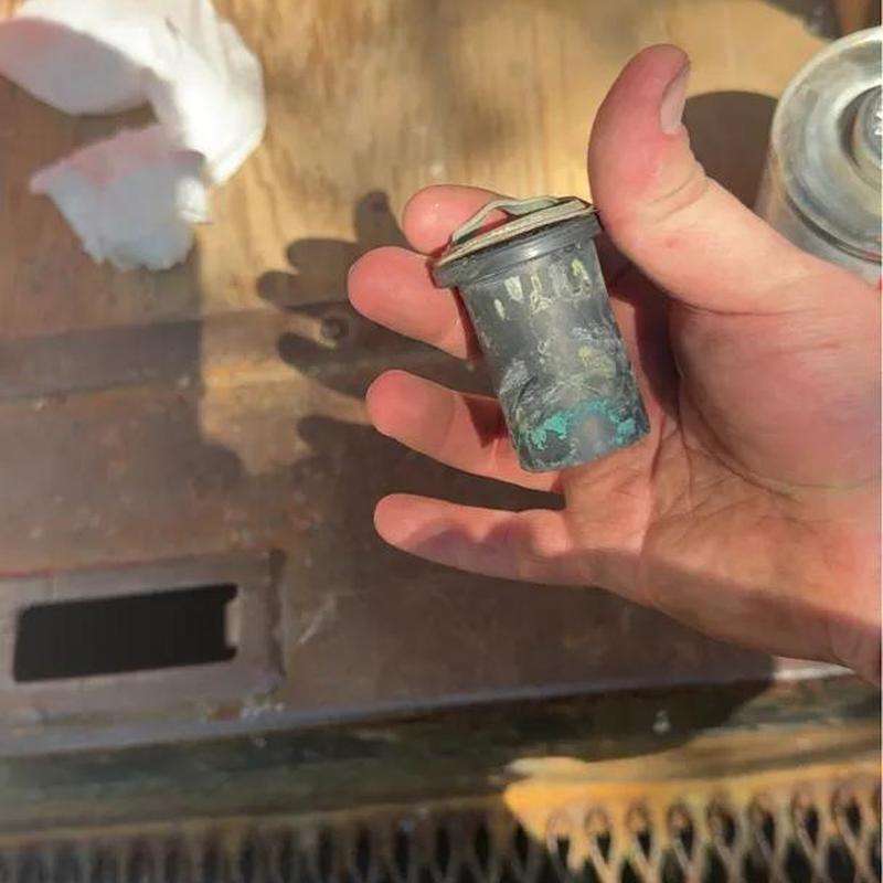 Urinal flush valve component held during repair job