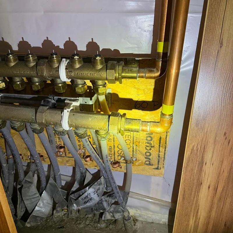 Copper piping and brass manifold plumbing system installation