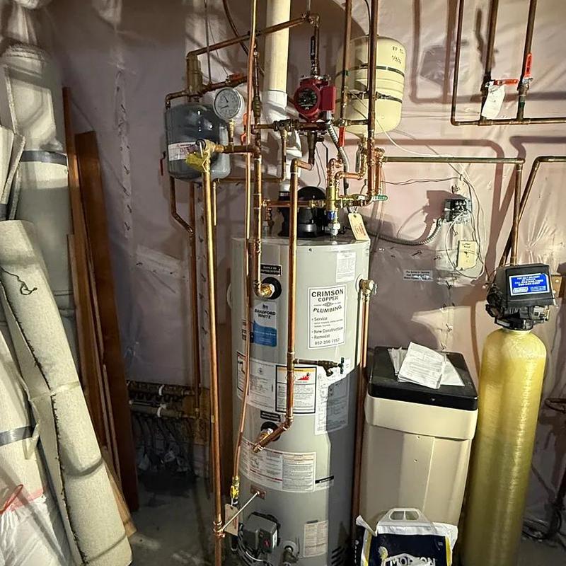 Water heater and plumbing pipes installation in basement
