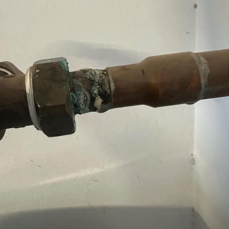 1-inch copper pipe with corrosion at solder joint