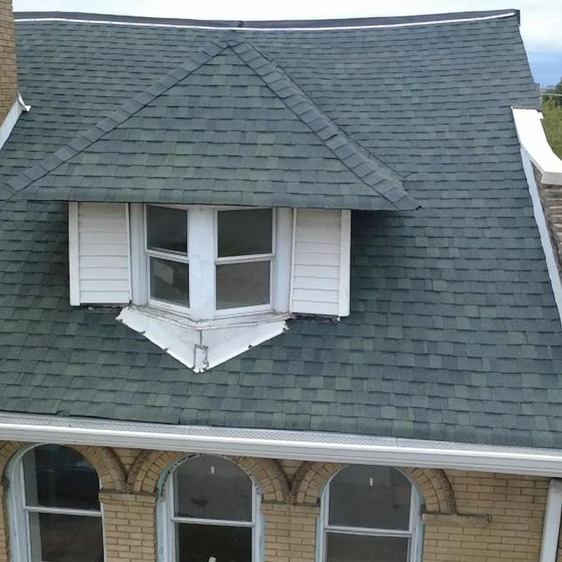 Shingle roof with dormer window and gutter system