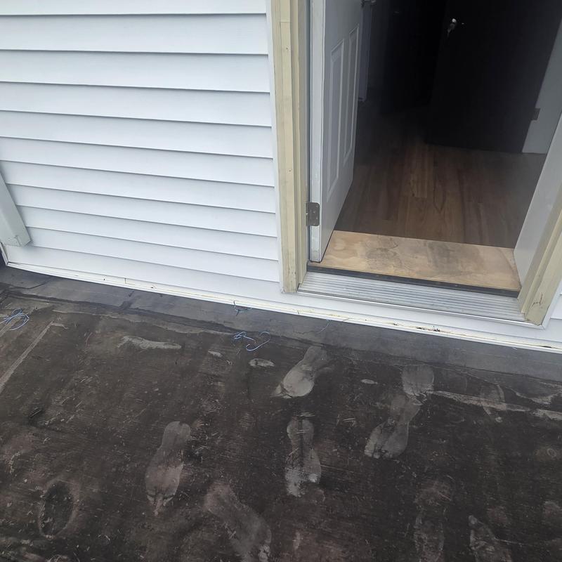 Flat roof surface with footprint marks near door threshold