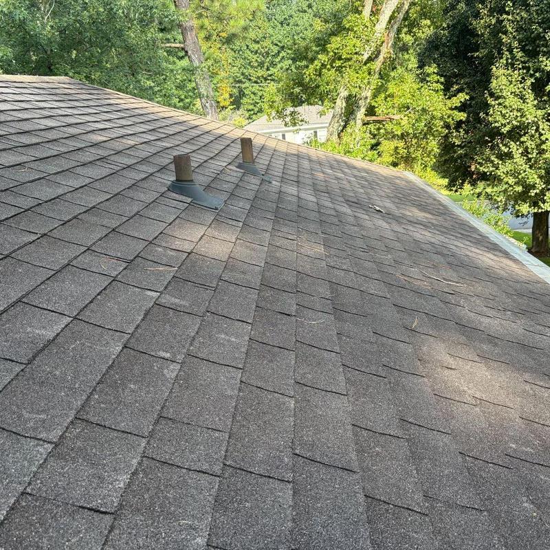 Shingle roof with vent pipe seals and replaced shingles Shingle roof with vent pipe seals and replaced shingles