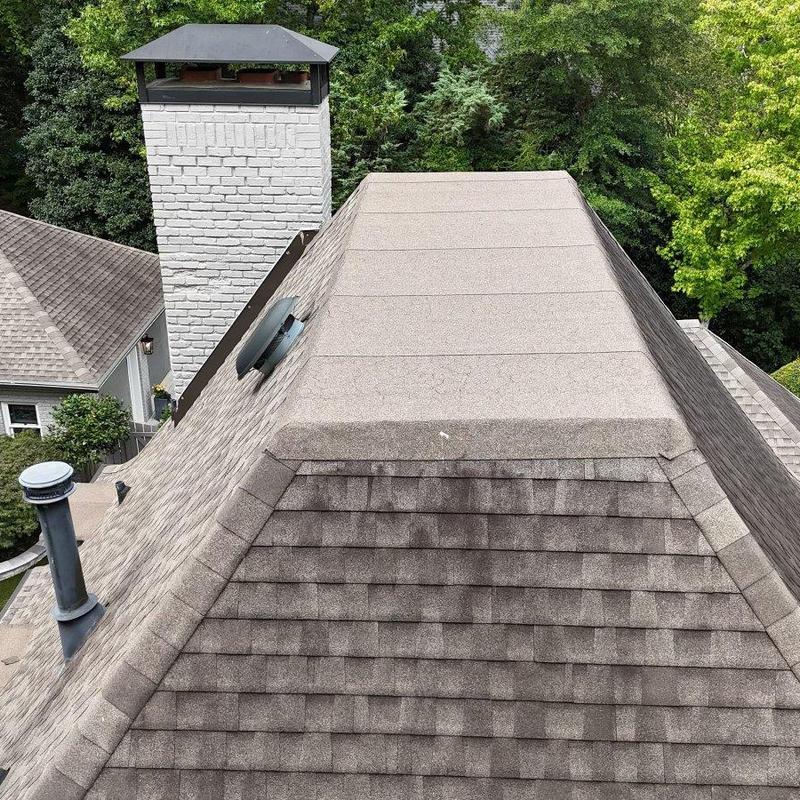 Low-slope roof section with sealed leak points and chimney Low-slope roof section with sealed leak points and chimney