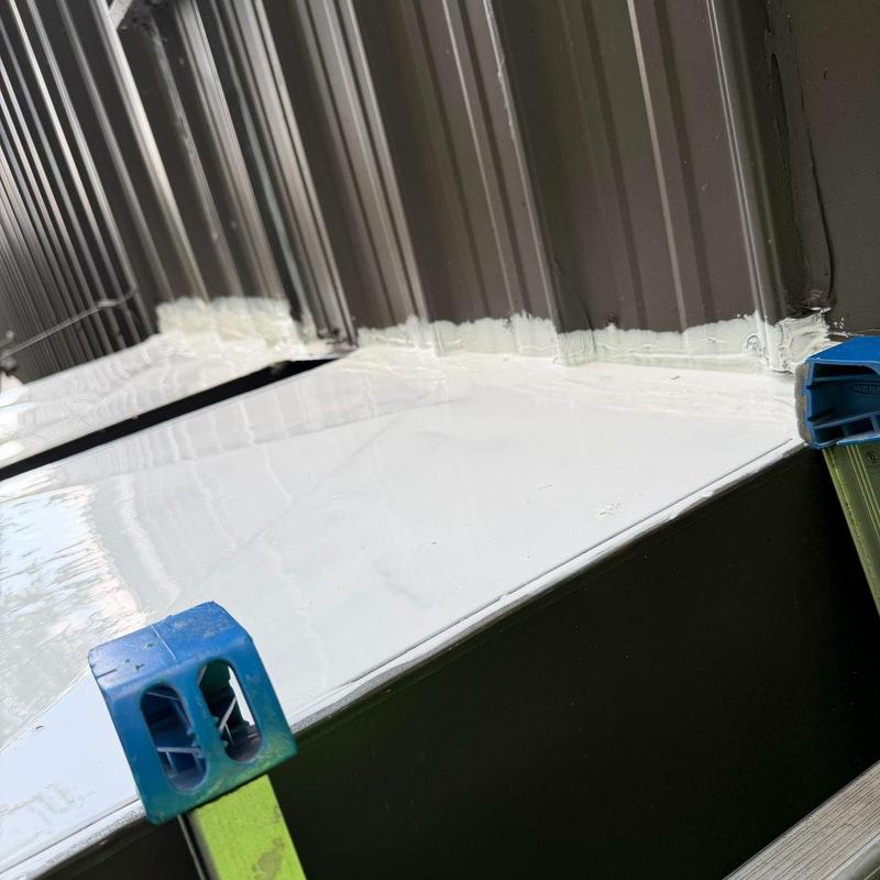 Low-slope roof membrane sealed at metal wall panels Low-slope roof membrane sealed at metal wall panels