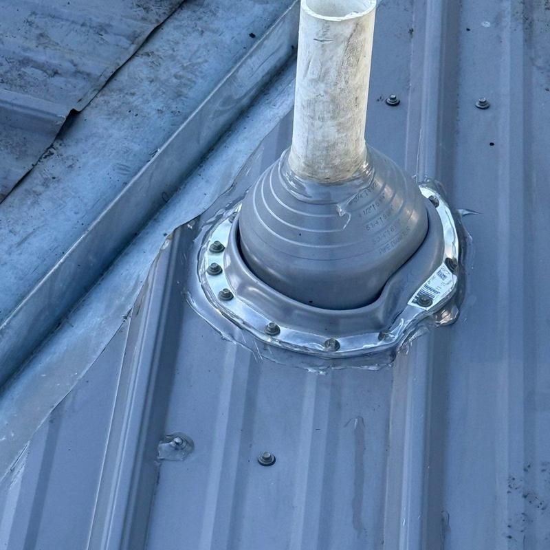 Metal roof pipe flashing sealed with screws and sealant Metal roof pipe flashing sealed with screws and sealant