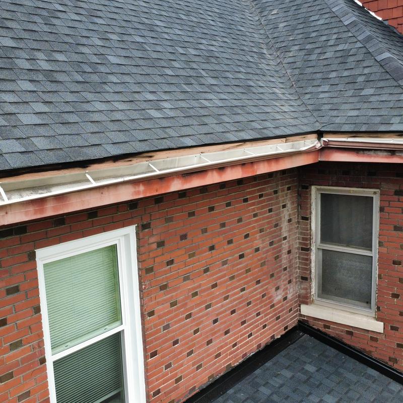 Gutter fascia and soffit with wood rot on brick home