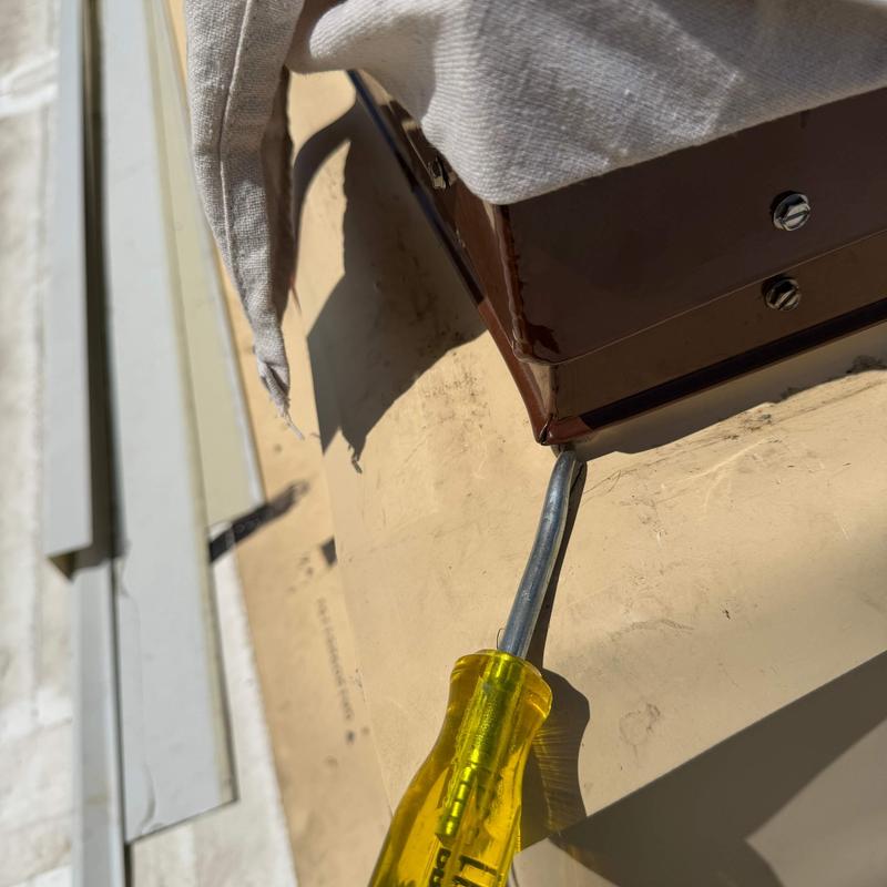 Roof flashing with screwdriver for repair work Roof flashing with screwdriver for repair work