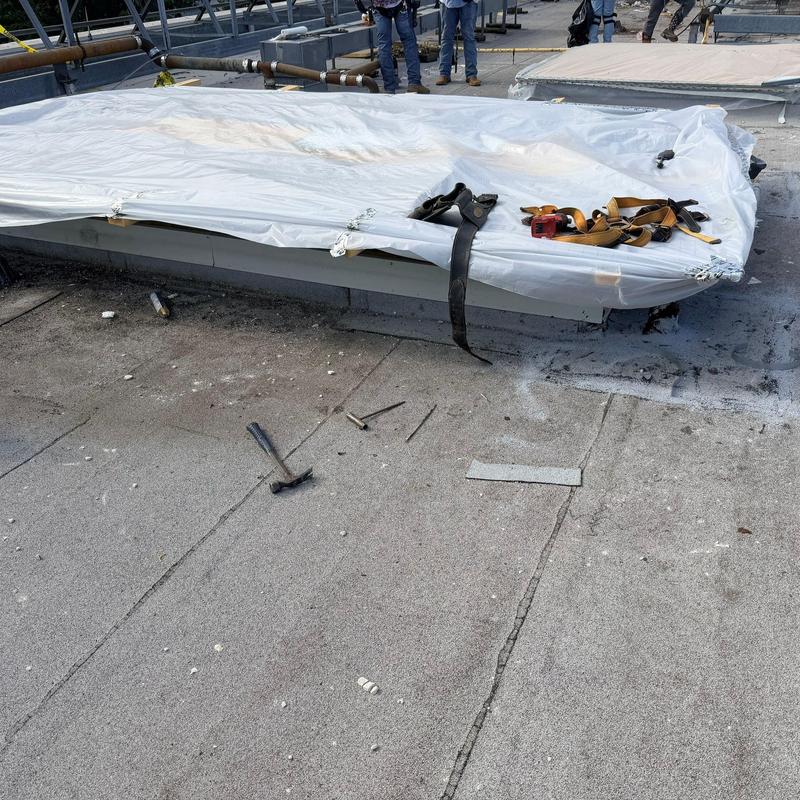 Commercial roof air vent covered with plastic tarp Commercial roof air vent covered with plastic tarp