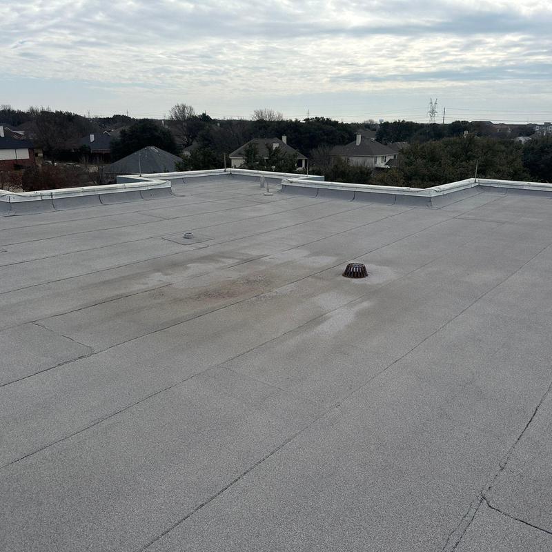 Flat commercial roof surface with drain and flashing edges Flat commercial roof surface with drain and flashing edges
