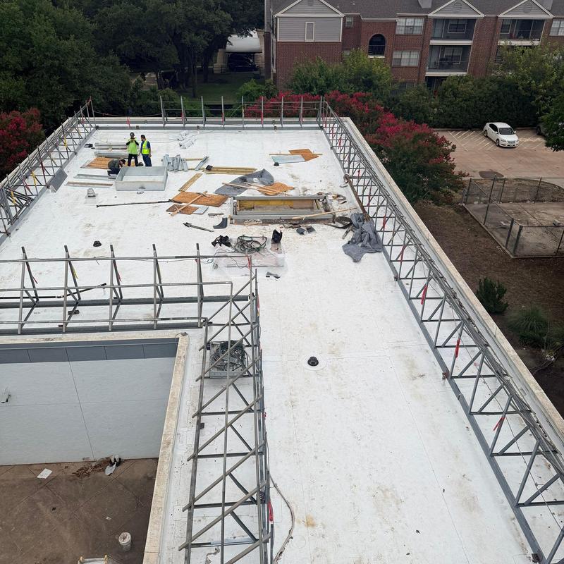 Commercial flat roof with safety railing installation Commercial flat roof with safety railing installation