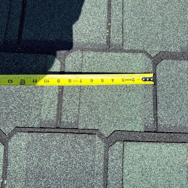 Architectural asphalt roofing shingles with measuring tape Architectural asphalt roofing shingles with measuring tape