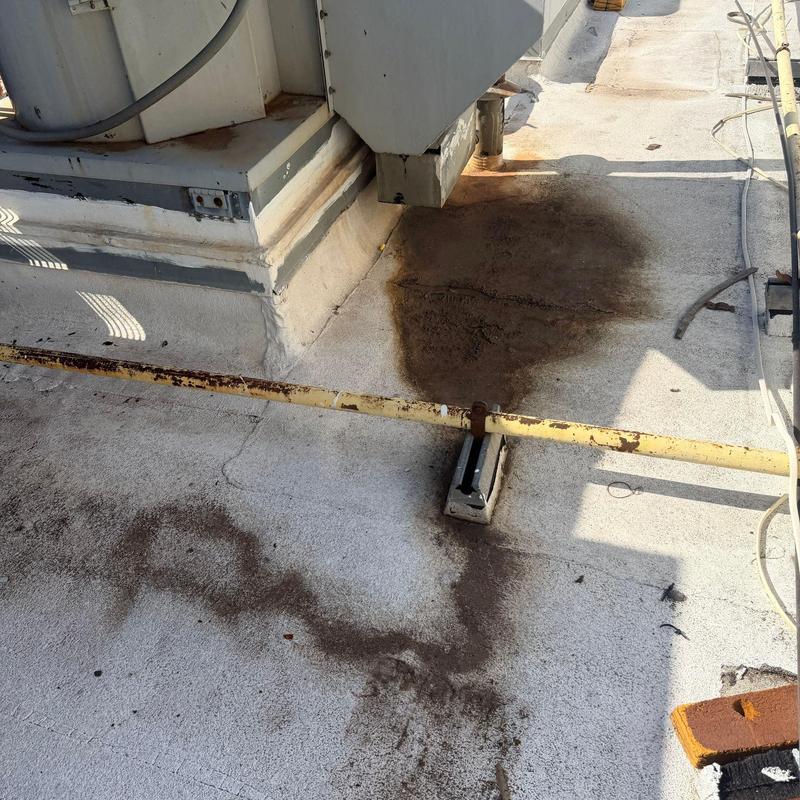 Roof membrane with water and dirt stains on rooftop Roof membrane with water and dirt stains on rooftop