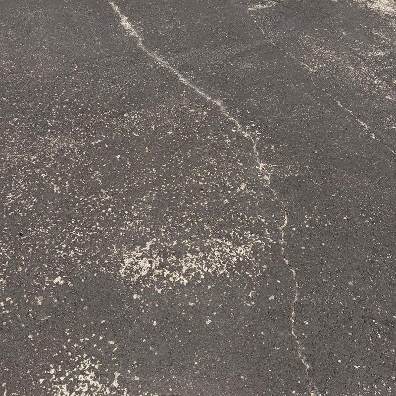 Commercial roof surface with hail damage and cracks Commercial roof surface with hail damage and cracks