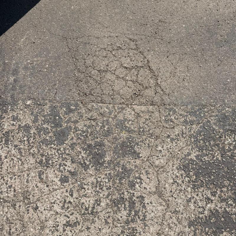Asphalt pavement surface with cracking and wear Asphalt pavement surface with cracking and wear
