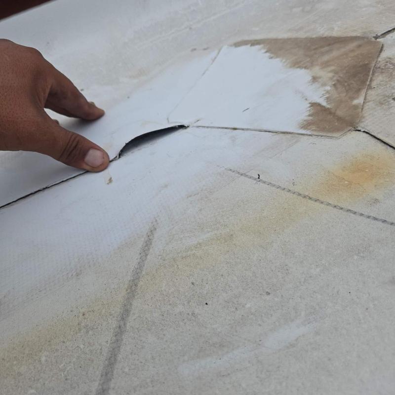 Roofing membrane seam lift with hand inspection Roofing membrane seam lift with hand inspection