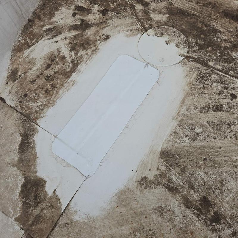 Roofing membrane patch on dirty commercial roof surface Roofing membrane patch on dirty commercial roof surface