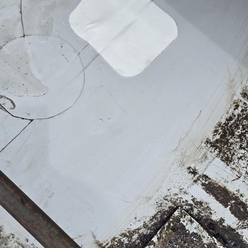 Roofing membrane with patches and dirt buildup close-up Roofing membrane with patches and dirt buildup close-up