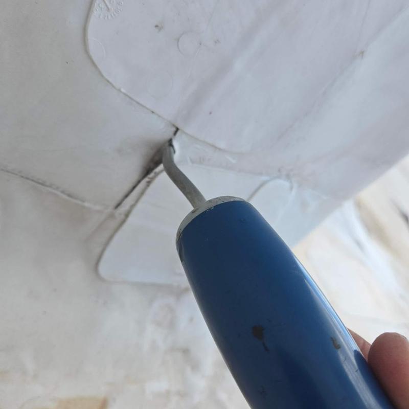 Roof membrane seam cold-weld repair tool closeup Roof membrane seam cold-weld repair tool closeup