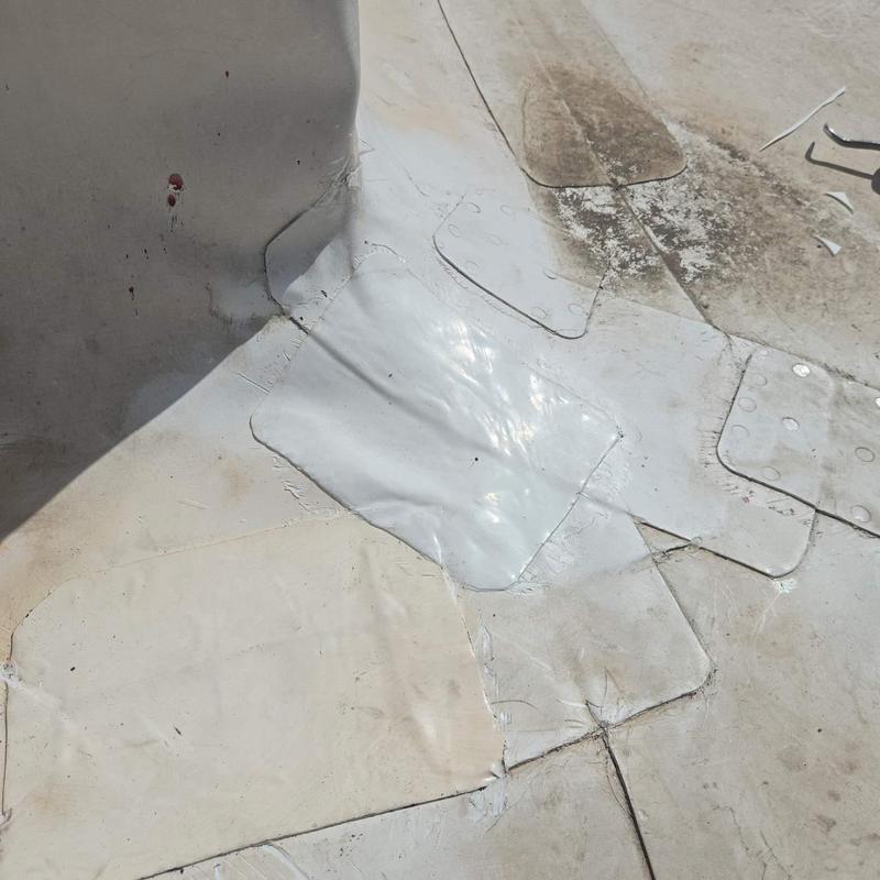 Roof membrane seams with cold-weld patch repairs Roof membrane seams with cold-weld patch repairs