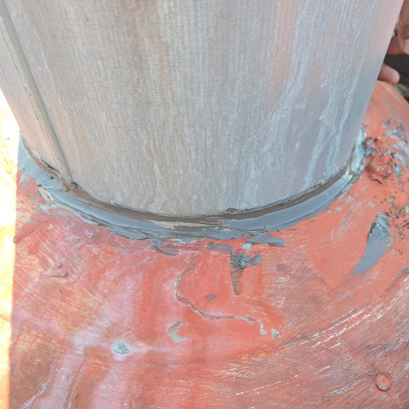 Pipe flashing with sealant on metal roof surface Pipe flashing with sealant on metal roof surface