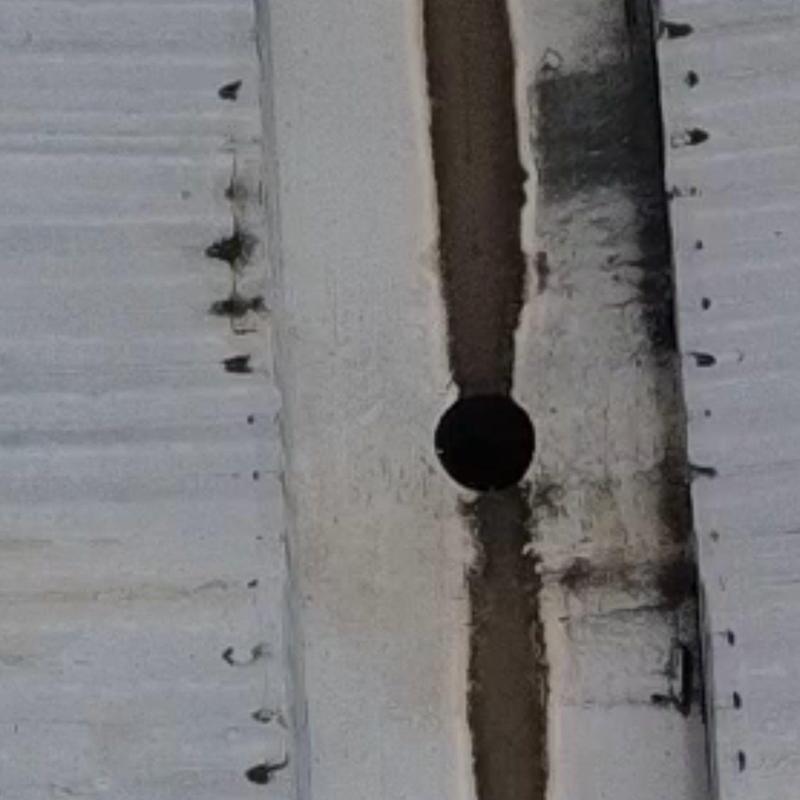 Commercial metal roof with vent pipe hole and corrosion Commercial metal roof with vent pipe hole and corrosion