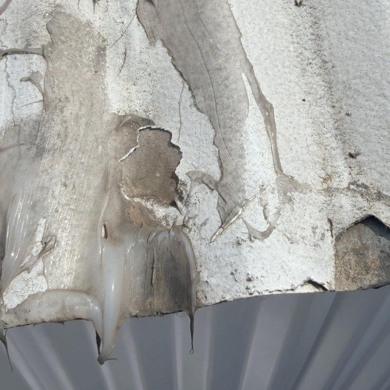 Metal roofing panel with corrosion and sealant buildup Metal roofing panel with corrosion and sealant buildup