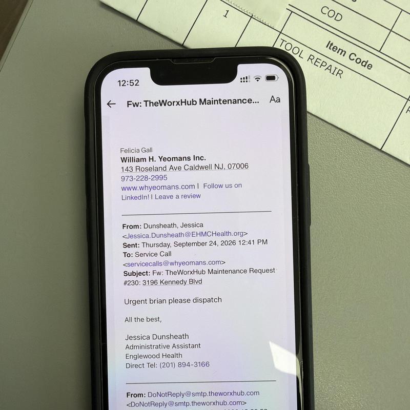 Email message on smartphone screen showing maintenance request Email message on smartphone screen showing maintenance request