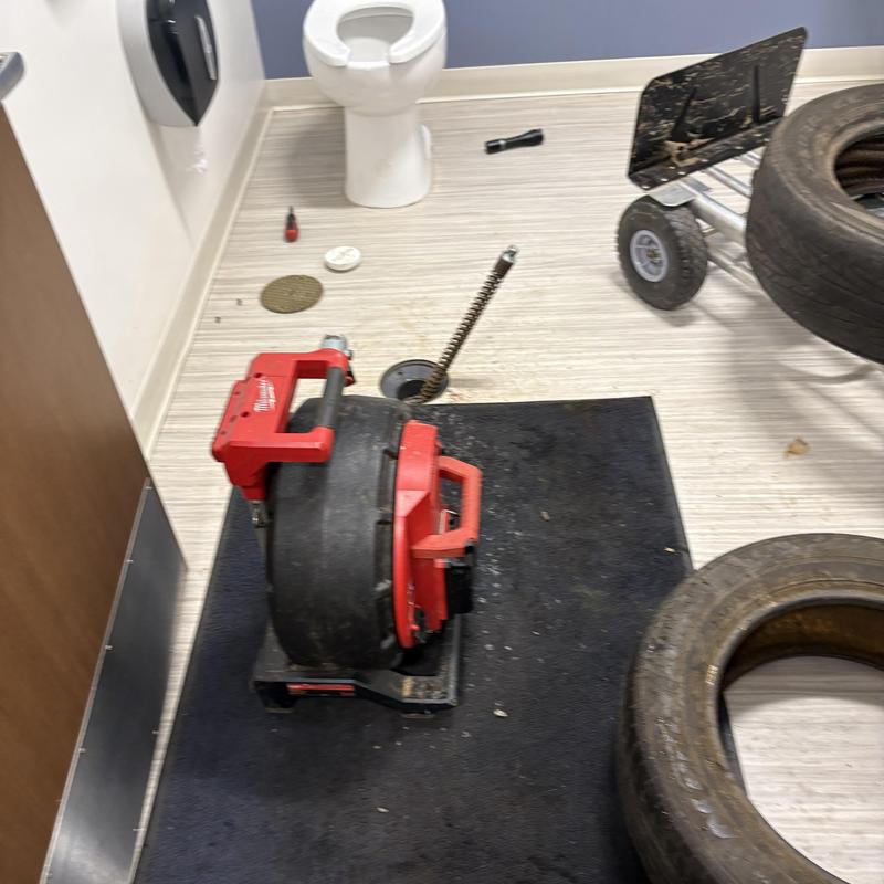 Main line drain auger with cleaning tools in bathroom Main line drain auger with cleaning tools in bathroom