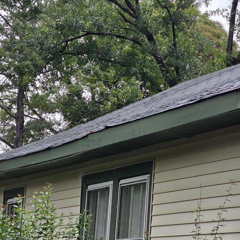 Chimney roof leak area with damaged shingles Chimney roof leak area with damaged shingles