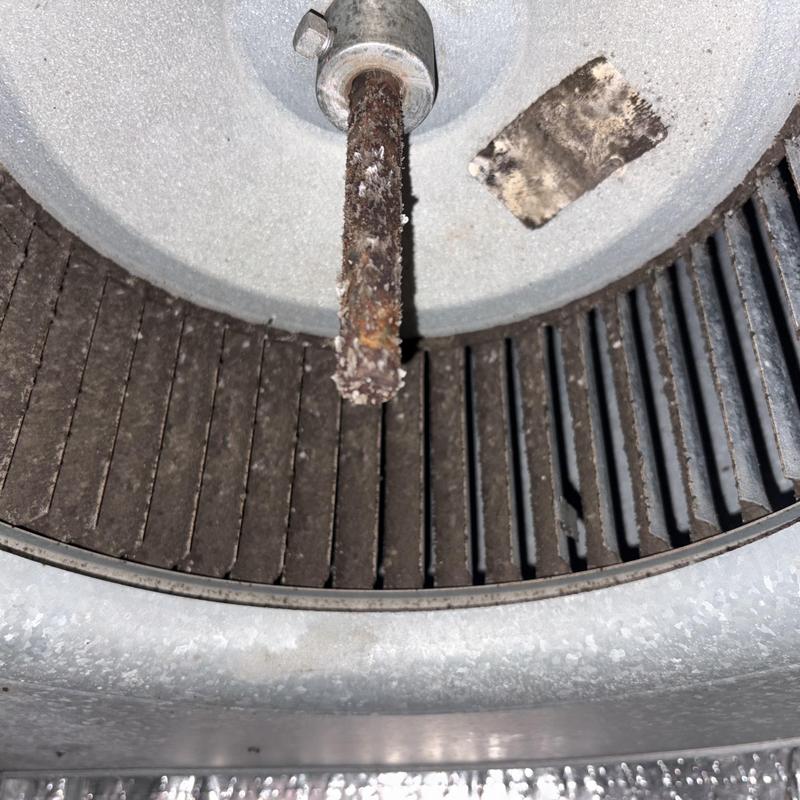 HVAC blower wheel with rust and debris buildup