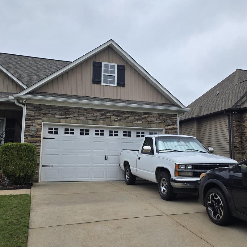Garage door with window panels on suburban home Garage door with window panels on suburban home