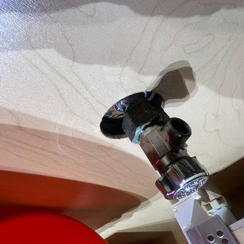 Corroded angle stop valve under sink in cabinet