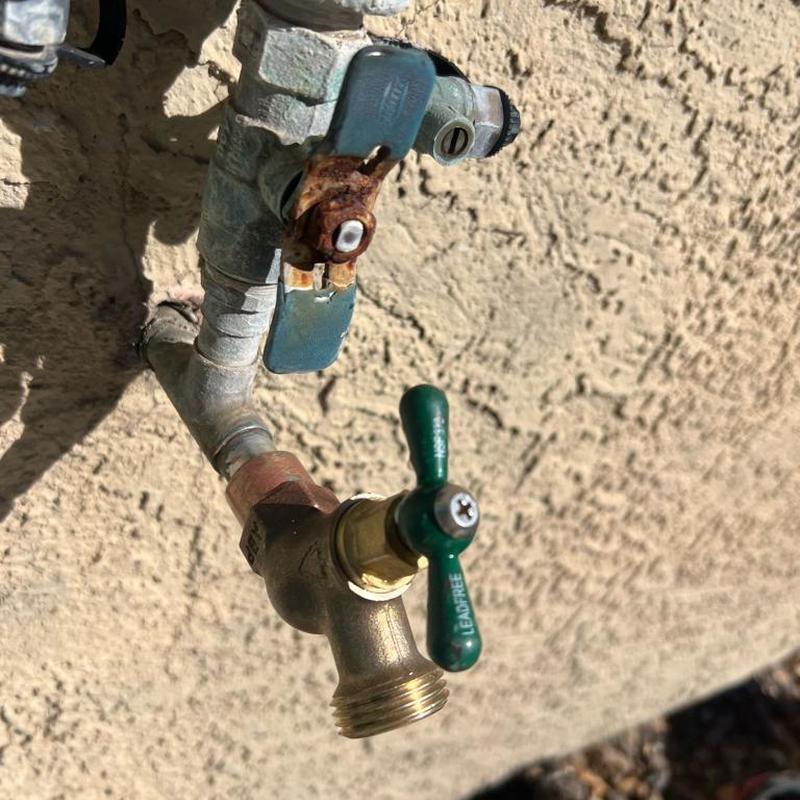 New brass multiturn hose bib valve on wall