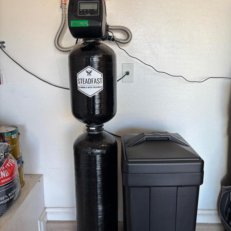 Green Titan 1000 water softener system installed in garage