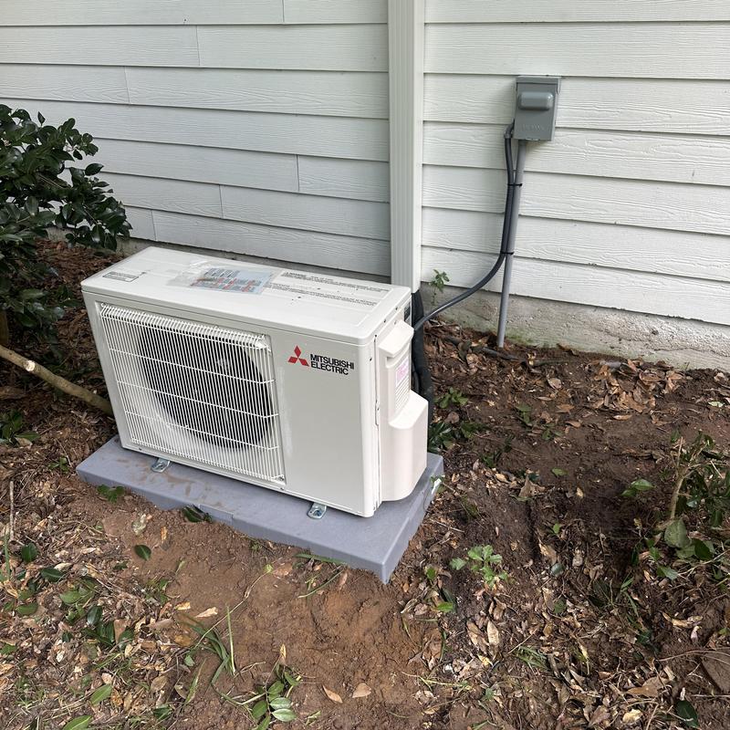 Mini split outdoor unit installed on concrete pad