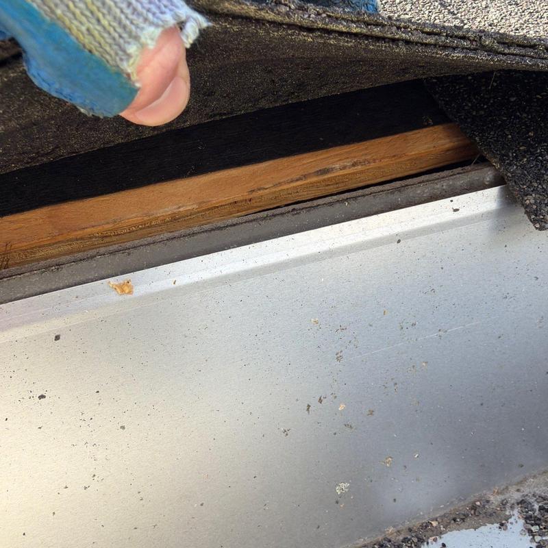 Roof flashing inspection under lifted shingles