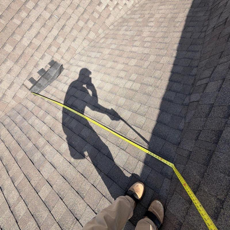 Roof shingles measurement with tape during inspection