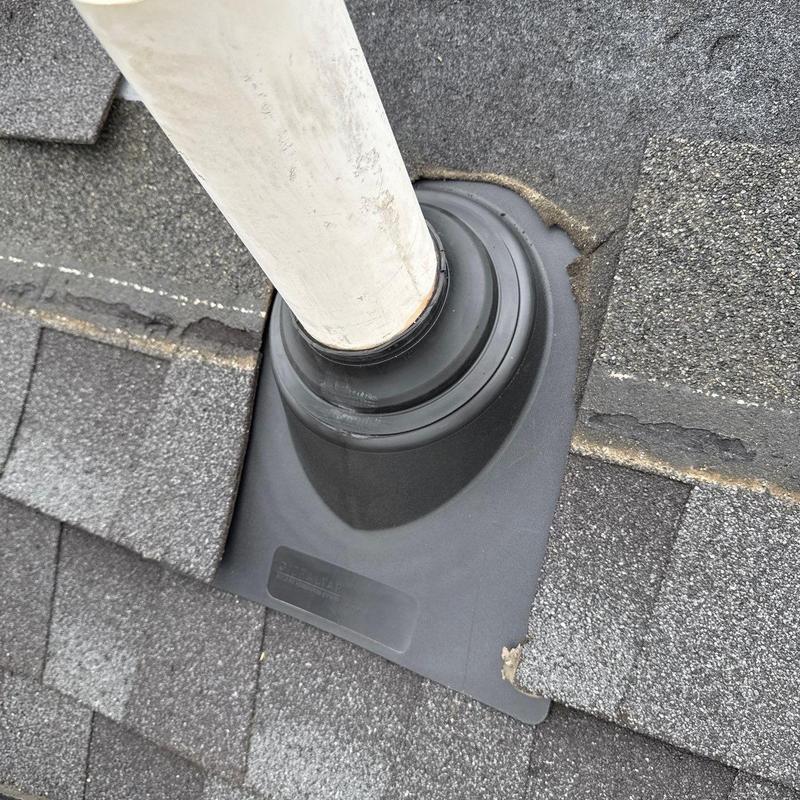 Roof pipe flashing and asphalt shingles on roof