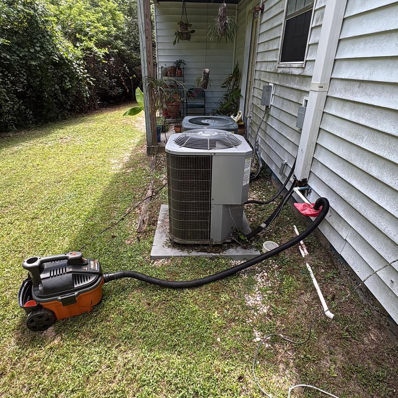 Air conditioner condensate drain with vacuum tool attached