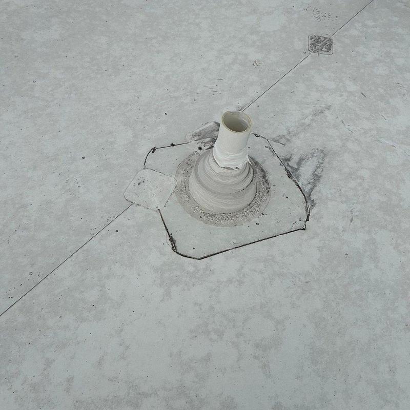 Commercial roof drain pipe flashing on flat roof surface