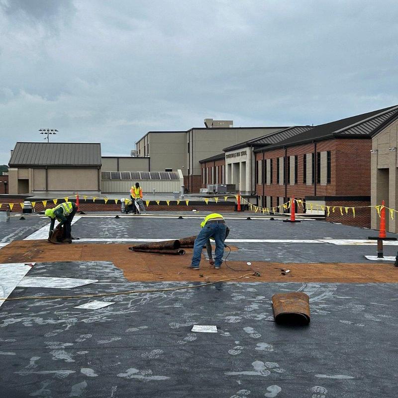 Commercial flat roof membrane installation on school building Commercial flat roof membrane installation on school building