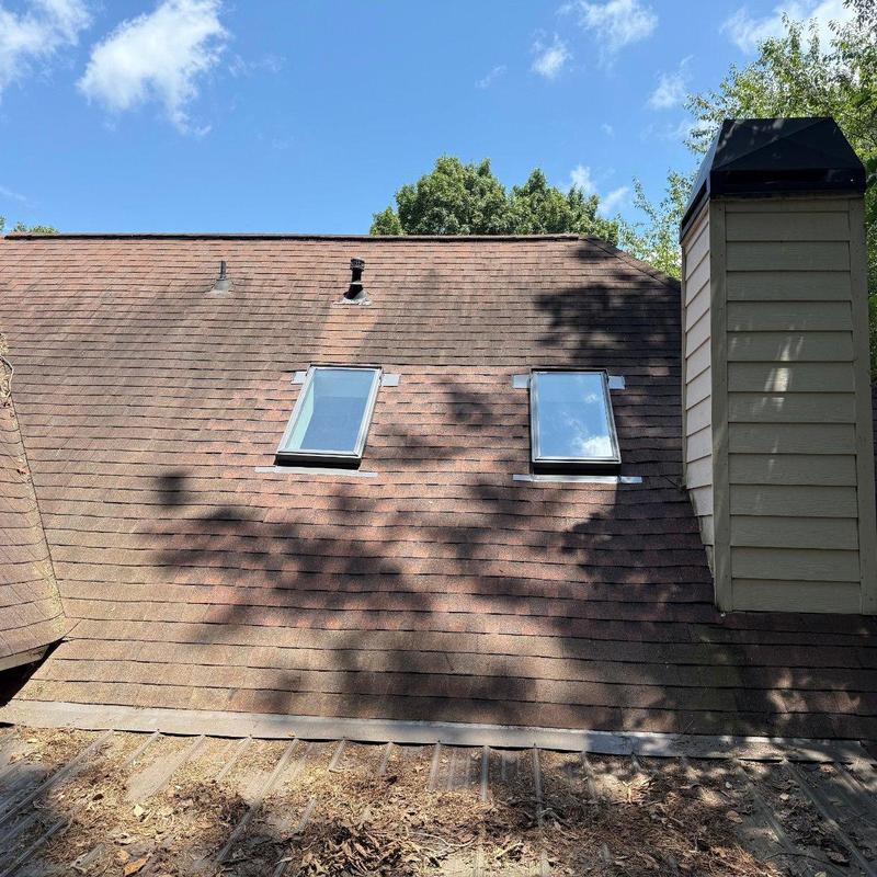 Asphalt shingle roof with skylights and chimney panel Asphalt shingle roof with skylights and chimney panel