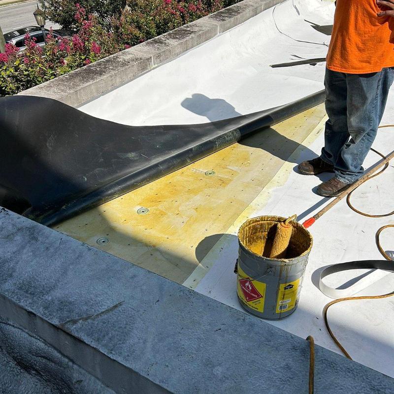 TPO membrane roofing with adhesive application on commercial roof