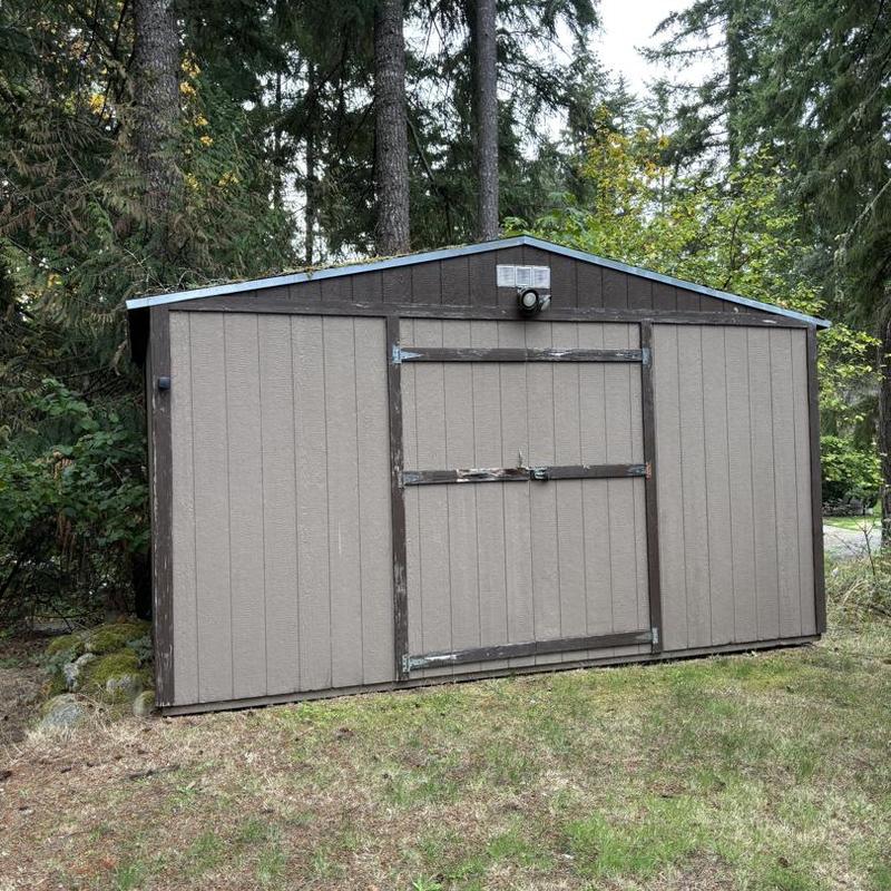 Metal roofing on backyard storage shed in forest