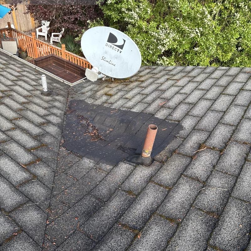 Asphalt shingle roof patch near satellite dish and vent pipe