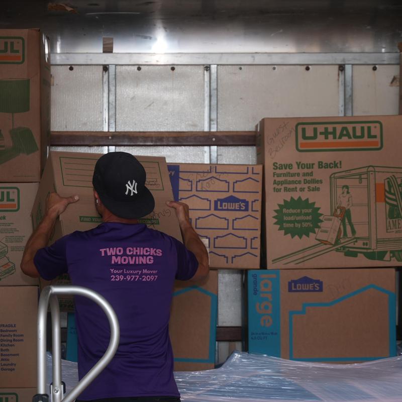 Moving boxes being packed in moving truck