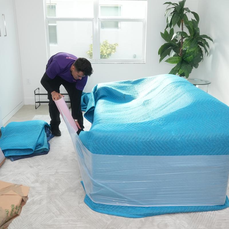 Mattress wrapping with protective moving blankets and plastic wrap