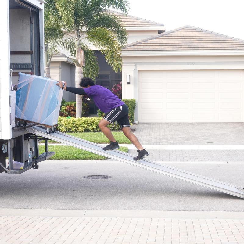 Furniture moving dolly loading onto truck ramp