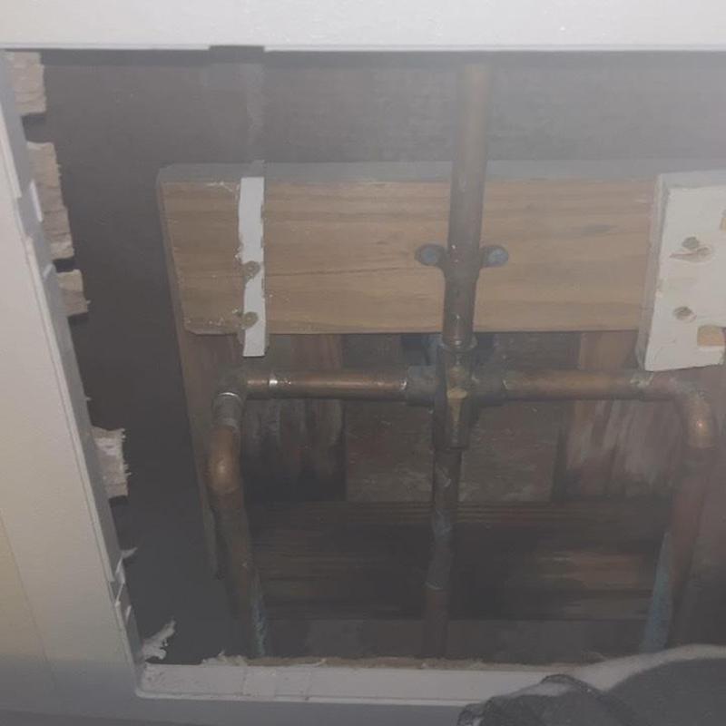 Copper plumbing pipes behind drywall access panel in ceiling Copper plumbing pipes behind drywall access panel in ceiling